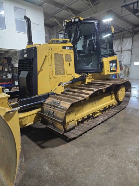 Caterpillar D6K2 bulldozer from 2020 with tracked undercarriage, yellow body, and enclosed cab.