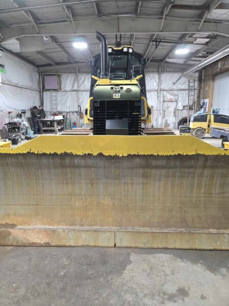 Heavy-duty 2020 Caterpillar D6K2 bulldozer with blade attachment inside a warehouse.
