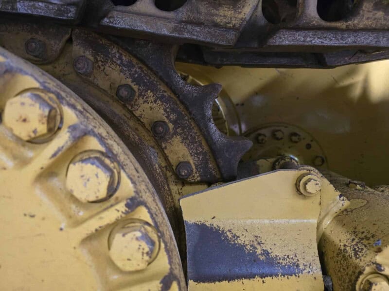 Close-up of the undercarriage and track components of a 2020 Caterpillar D6K2 bulldozer.