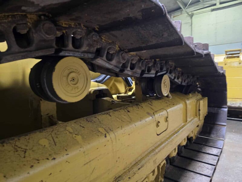 Close-up of the undercarriage and tracks of a 2020 Caterpillar D6K2 bulldozer.
