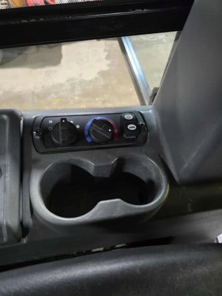Operator cabin control panel with climate controls in a 2020 Cat D6K2 bulldozer.