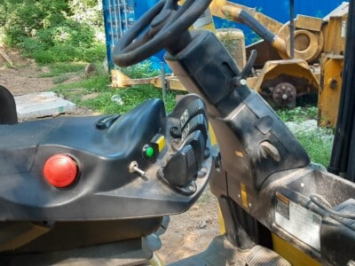 Close-up of Hyster E50XM forklift dashboard and steering wheel with control buttons.