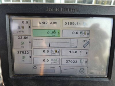 John Deere 6125R tractor display screen showing operational data and settings.