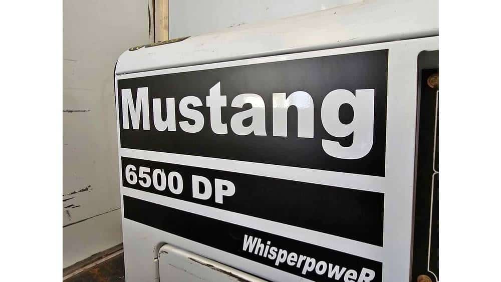 Mustang 6500 DP industrial generator with WhisperpowerR branding, white exterior, and black logo.
