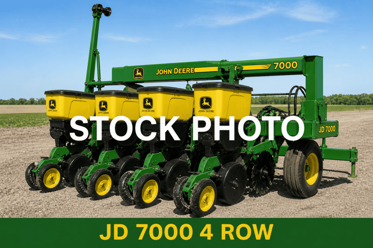John Deere 7000 4-row planter for agricultural planting, green and yellow equipment in a field.