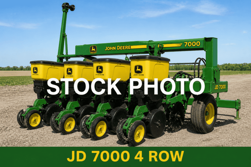 John Deere 7000 4-row planter for agricultural planting, green and yellow equipment in a field.