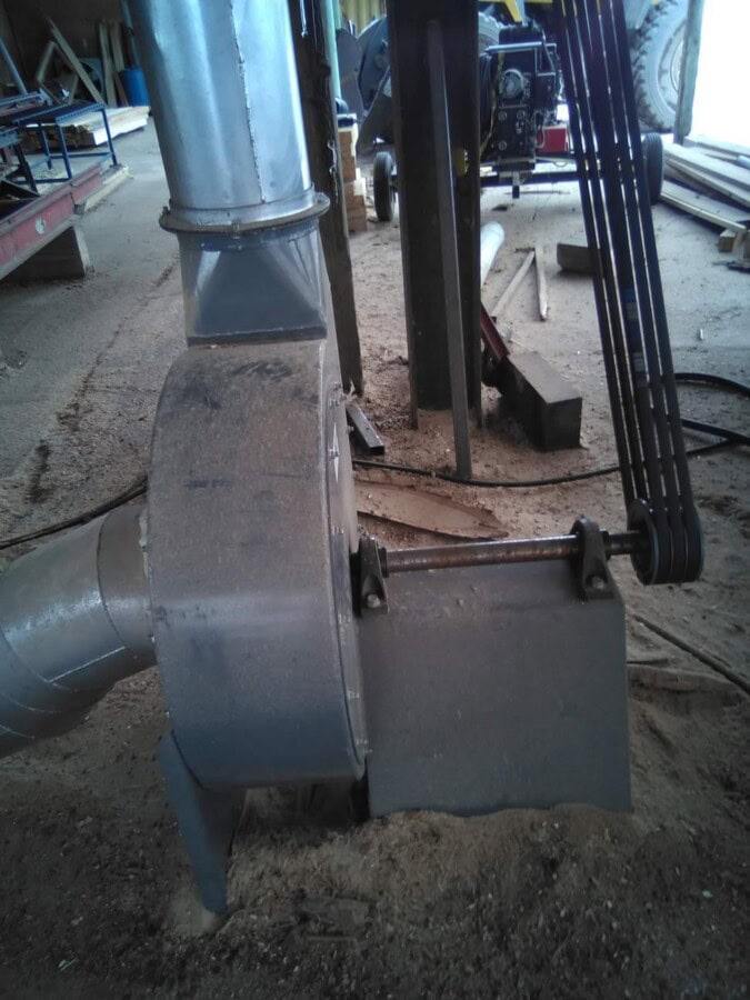 Industrial dust collection system with ductwork and blower, used in manufacturing facilities.