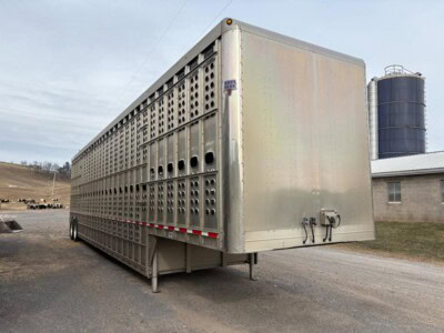 An image of a 2017 EBY 50-foot livestock trailer with ventilation holes parked outdoors.