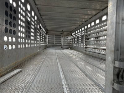 High-capacity 2017 EBY 50-foot aluminum livestock trailer interior with perforated side panels and textured flooring.