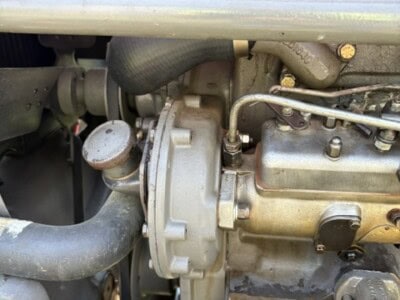 Close-up of the engine of a 1963 Massey Ferguson 50 tractor showing detailed mechanical parts.