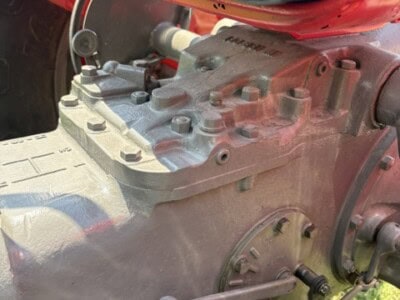 Close-up of Massey Ferguson 50 engine showing metallic components and controls.