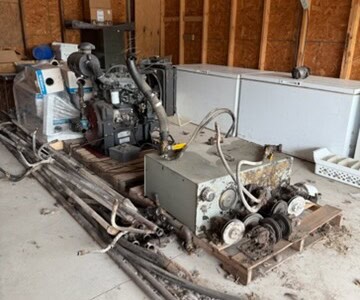 Iveco diesel power unit with hydraulic components and control panel in a workshop setting.