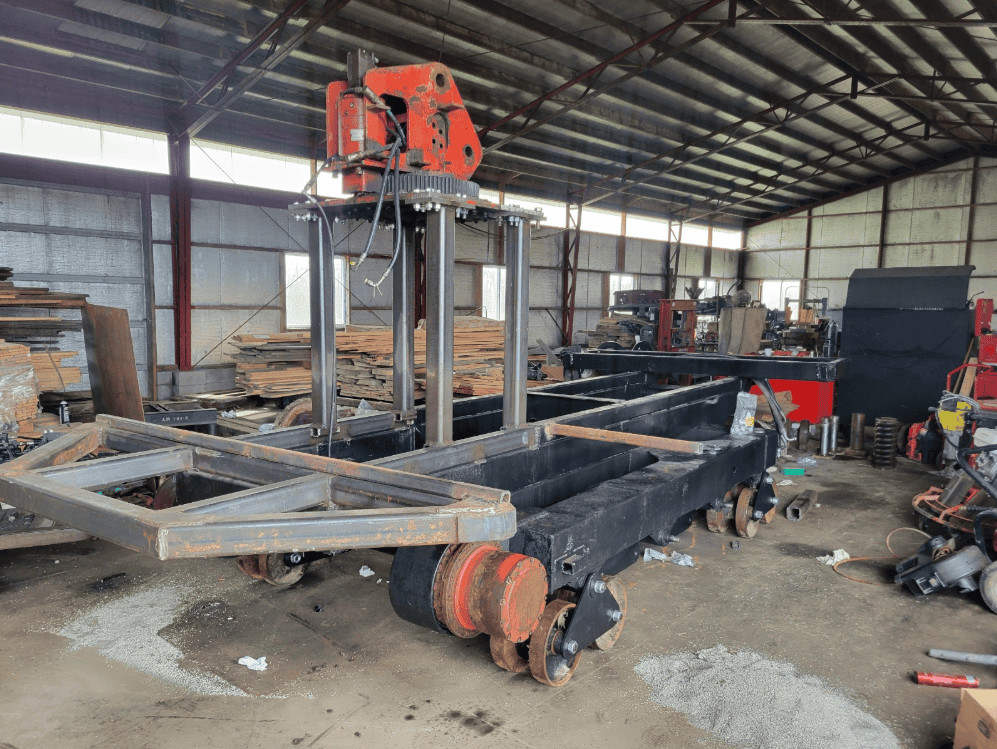 Heavy-duty industrial cutting or welding machine in a warehouse setting.