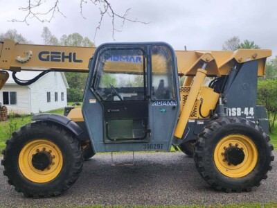 Heavy-duty 2017 Gehl RS8-44 telehandler with robust tires and hydraulic boom for construction and material handling tasks.