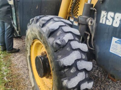 Heavy-duty construction equipment tire on a yellow and black loader, part of the 2017 Gehl RS8-44.