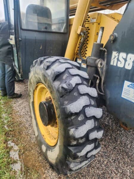 Heavy-duty construction equipment tire on a yellow and black loader, part of the 2017 Gehl RS8-44.