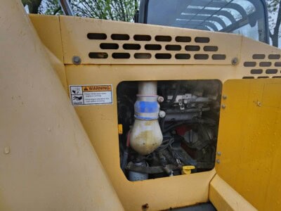 2017 Gehl RS8-44 compact loader engine compartment with visible components and warning label.