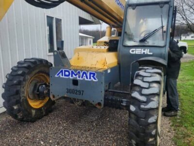 All-terrain telescopic boom lift, 2017 Gehl RS8-44, with yellow and black construction equipment, parked outdoors on gravel s.
