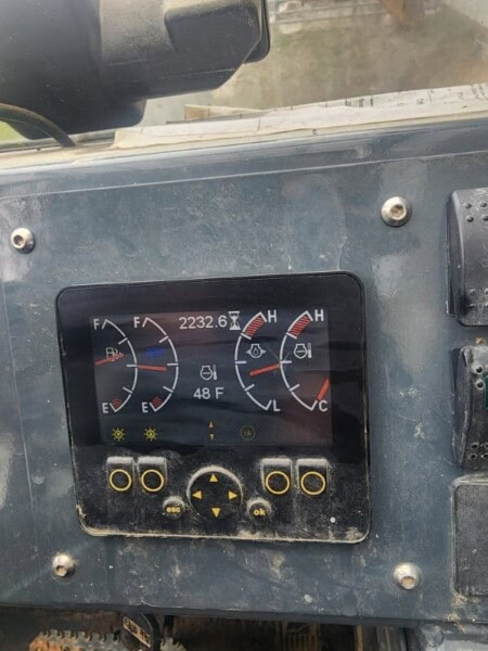 Control panel of a 2017 Gehl RS8-44 skid steer loader with temperature and fuel gauges.