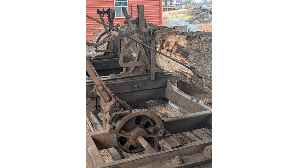 Old industrial rail grinder machine on tracks, used for railway maintenance and repair.