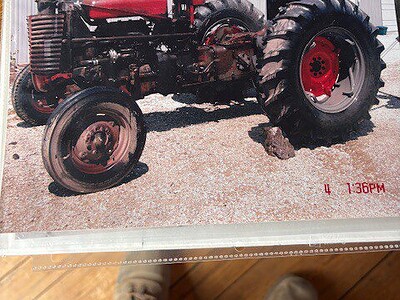 Vintage 1963 Massey Ferguson 50 tractor with large rear tires and red accents.