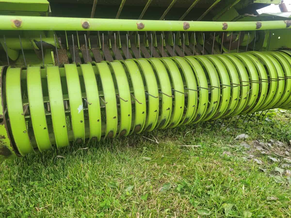 John Deere 6000 Series rotary hay rake, green color, used for agricultural hay collection.