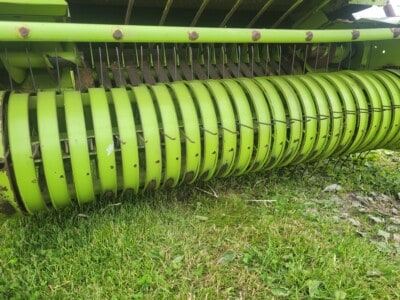 John Deere 6000 Series rotary hay rake, green color, used for agricultural hay collection.