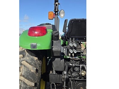 John Deere 5075E tractor with rear hydraulic system and large rear tire.