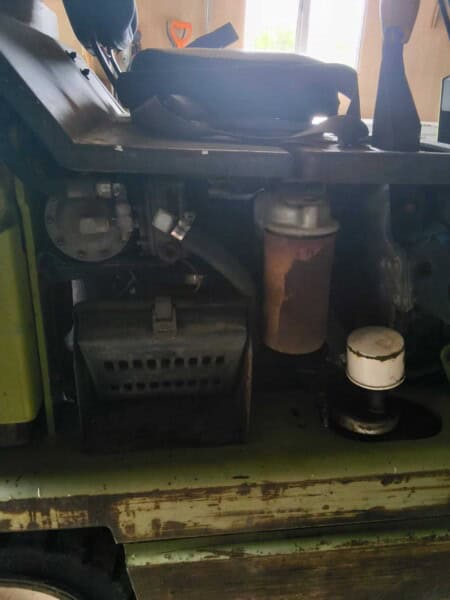 Close-up of engine and hydraulic parts inside a Clark 3000 LB forklift.