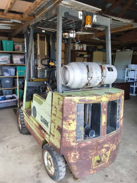 Clark forklift with propane tank, vintage model, used for material handling in a warehouse environment.