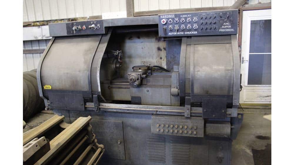 Industrial automatic chucking machine with control panel, used for precision machining in manufacturing facilities.