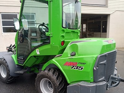 Avant 635 articulated loader with enclosed cab, green color, and robust tires, suitable for landscaping and construction work.