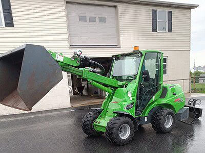 Compact green loader with a large bucket attachment, suitable for construction and landscaping tasks.