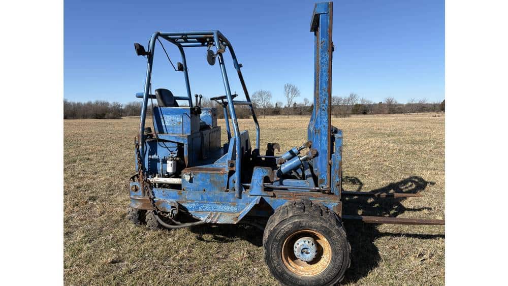 A.LT tag: Used blue forklift with lifting mast on open field, no visible year or model.