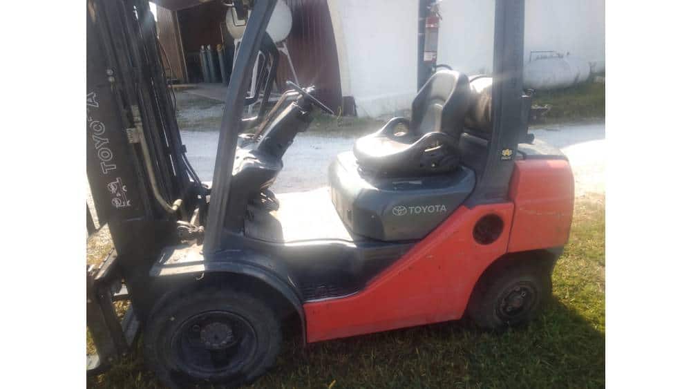 Red Toyota forklift from 2020 with black tires and operator seat, ideal for warehouse material handling.