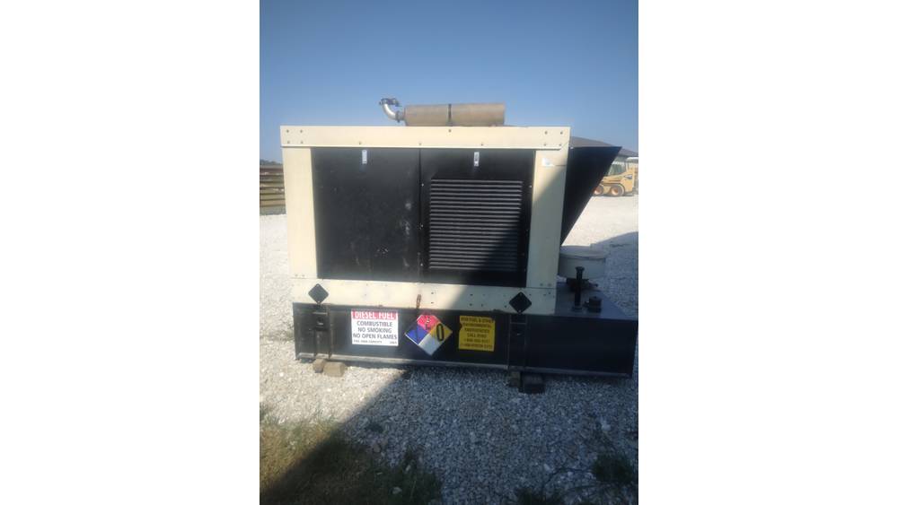 Industrial generator unit with black and beige casing, outdoor setting, no visible branding or model details.