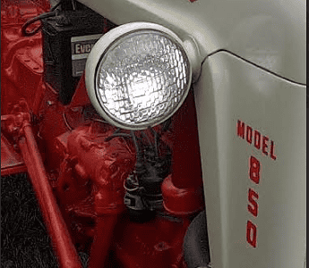 Ford Model 850 PowerMaster tractor with front headlight, vintage agricultural equipment.