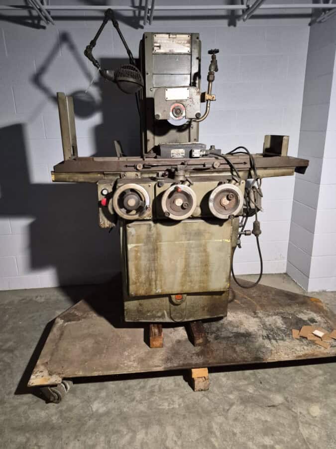 Vintage industrial metalworking machine with control dials and electrical components.