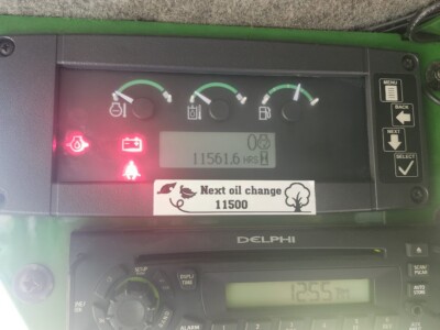 Tractor dashboard with fuel, oil, and battery gauges, and a reminder for next oil change at 11,500 hours.