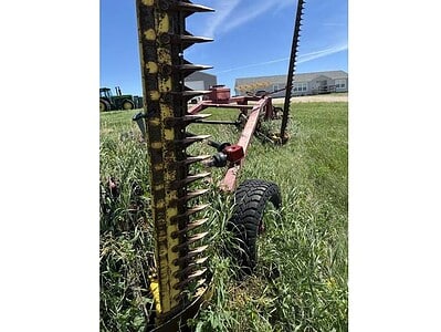 Rotary cutter attachment for tractors, featuring heavy-duty blades and a sturdy frame, ideal for land clearing and maintenanc.