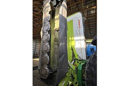 John Deere 2020 compact tractor with front loader and attachments, ideal for farming and landscaping tasks.