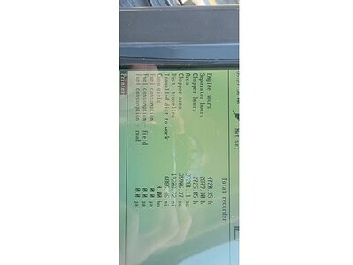 Green John Deere 6R Series tractor with detailed specifications label.
