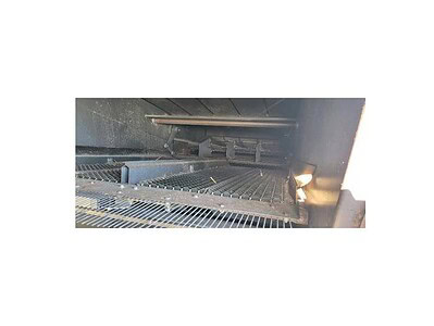 Conveyor system with metal rollers and industrial framework.