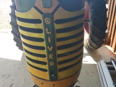 Oliver 77 tractor front view with yellow and black grille and large rear tires.