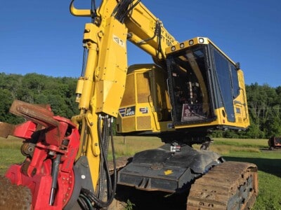 John Deere 85G hydraulic excavator with cab and tracked undercarriage on grassy field.