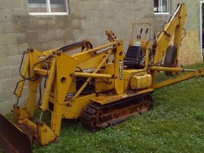 Yellow Mecalac 6MDX mini excavator with tracked undercarriage and hydraulic arm.