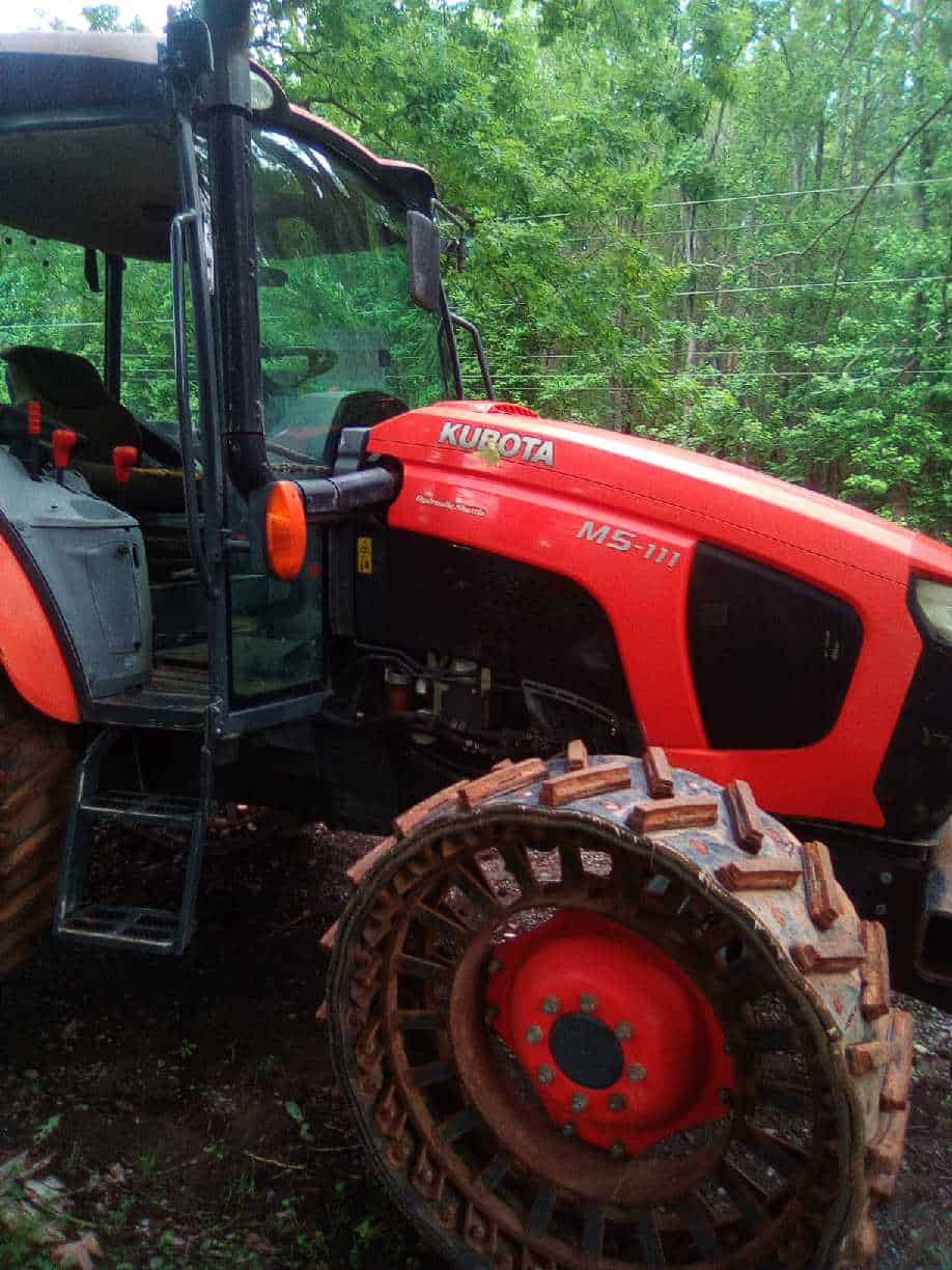 image000000 (11) 2018 Kubota M5-111 tractor with enclosed cab and track system for off-road use.