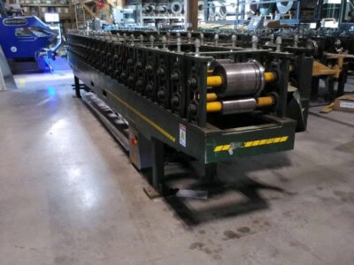 ACCUFORM overhead door trim machine with rollers and frame in industrial setting.