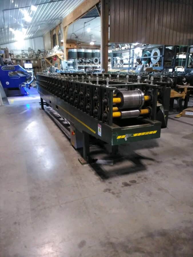 ACCUFORM overhead door trim machine with rollers and frame in industrial setting.