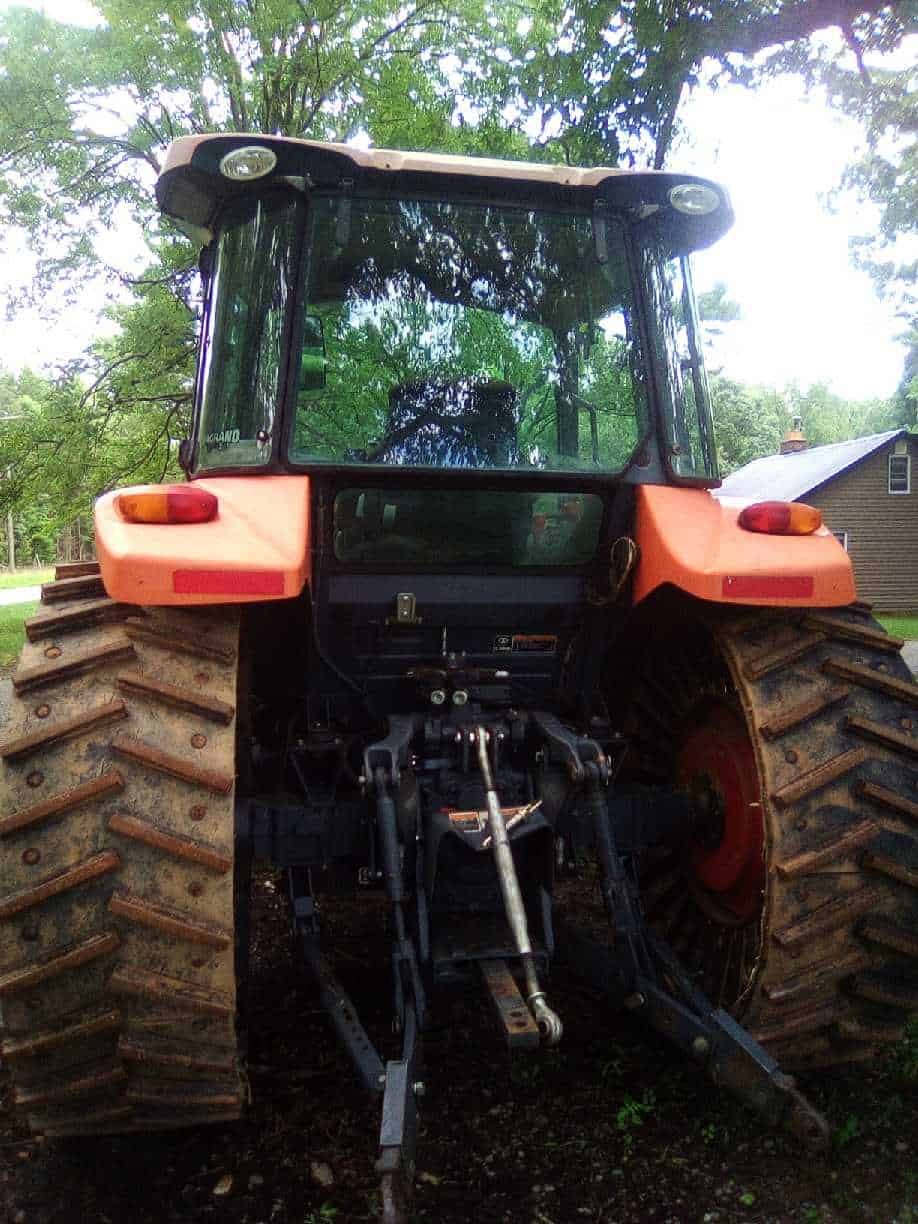 image000003 (2) 2018 Kubota M5-111 tractor with enclosed cab and large rear tires.